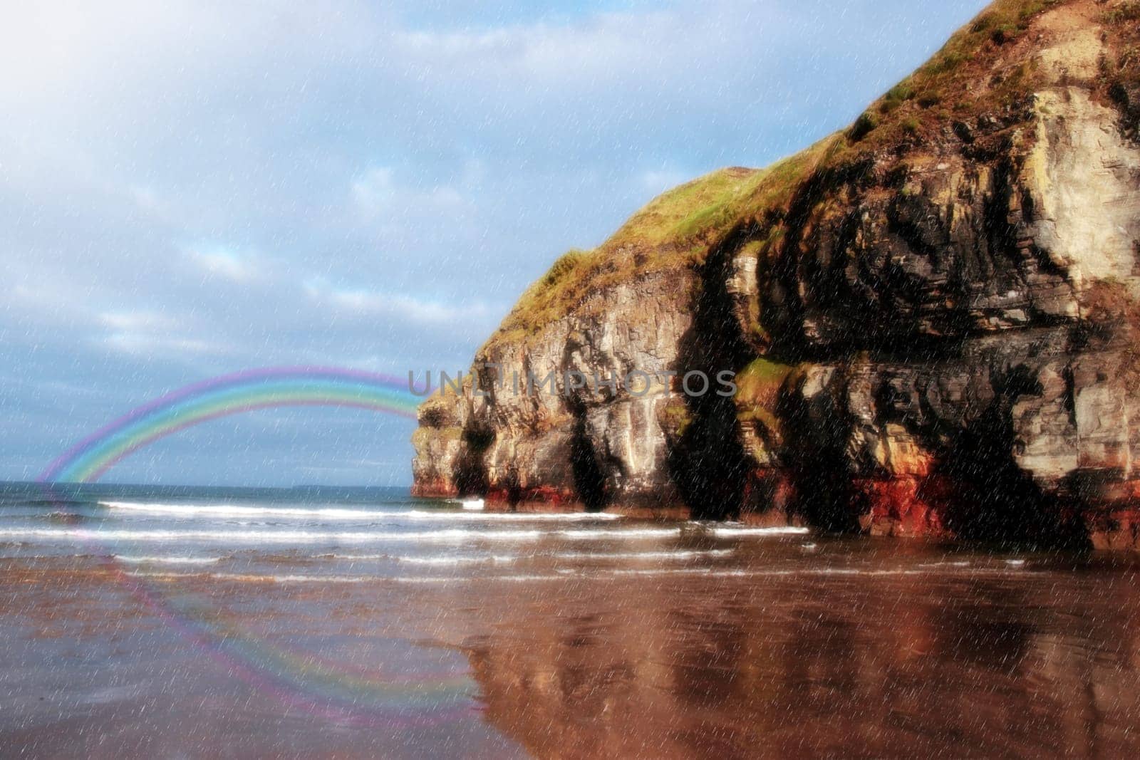 a view of the beach cliffs in ballybunion co kerry ireland with rainbow reflection on a wet rainy day
