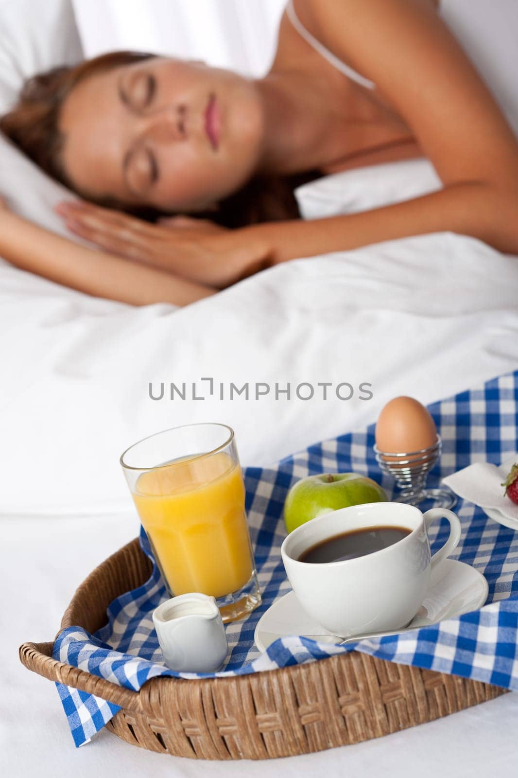 Young woman having home made breakfast in bed, sleeping