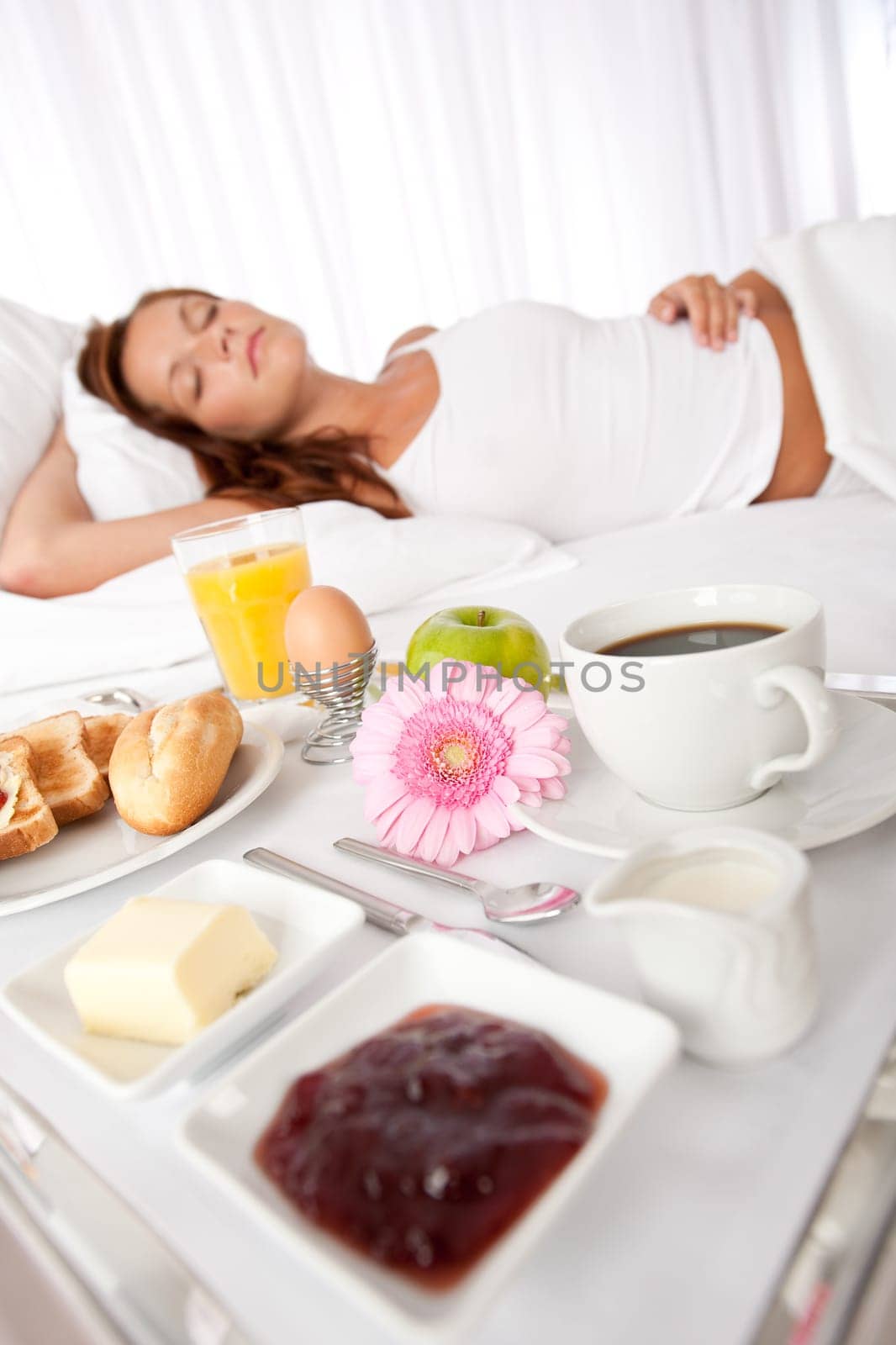 Young woman having breakfast in luxury hotel room