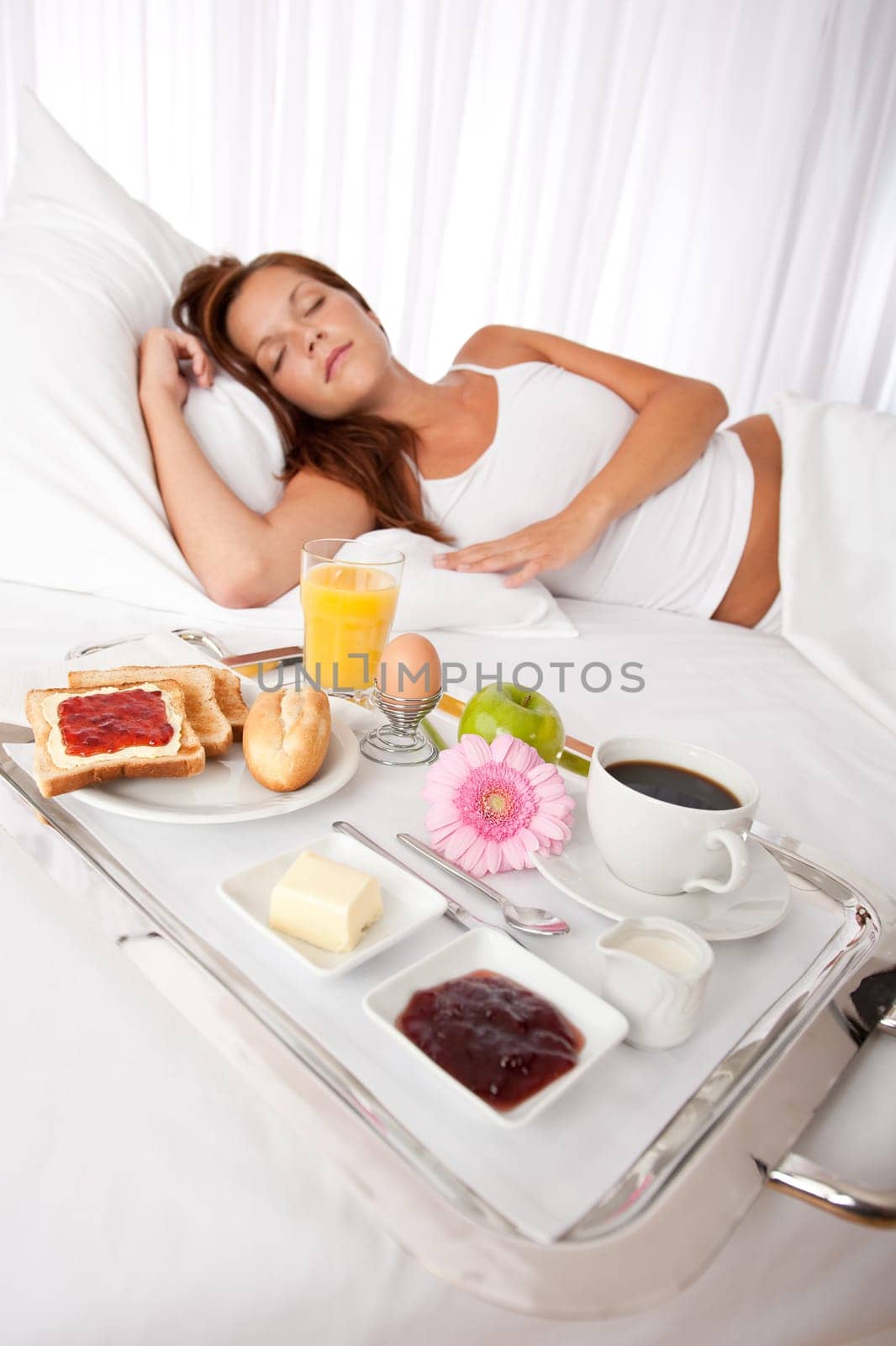 Young woman having breakfast in luxury hotel room