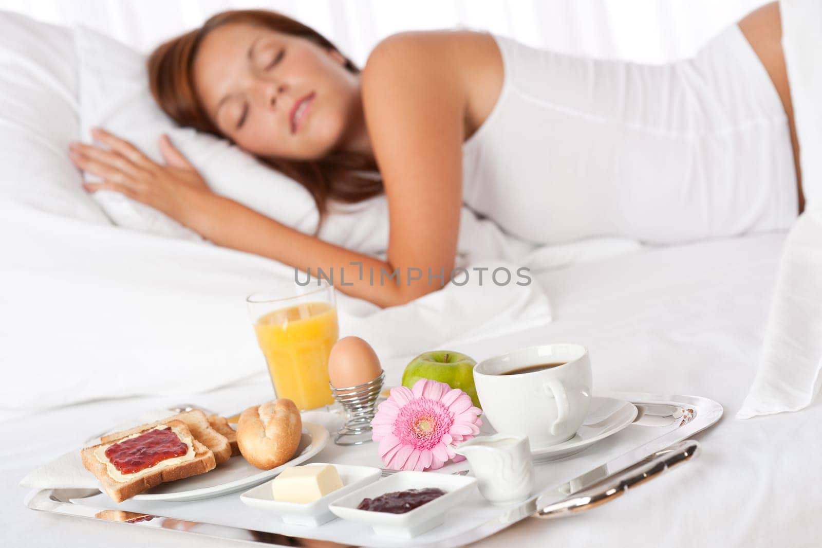 Young woman having breakfast in luxury hotel room