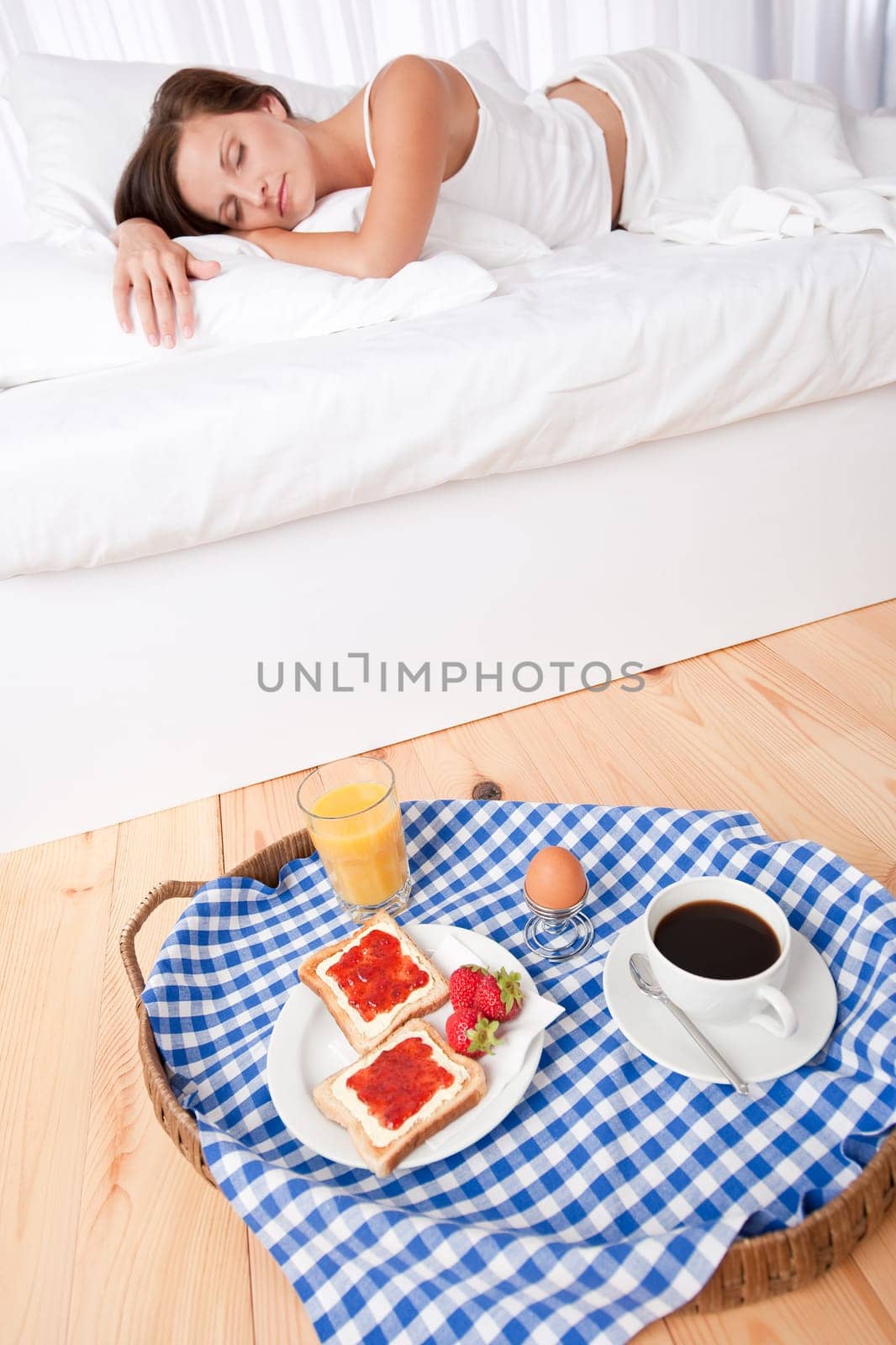 Woman having homemade breakfast lying in bed and sleeping