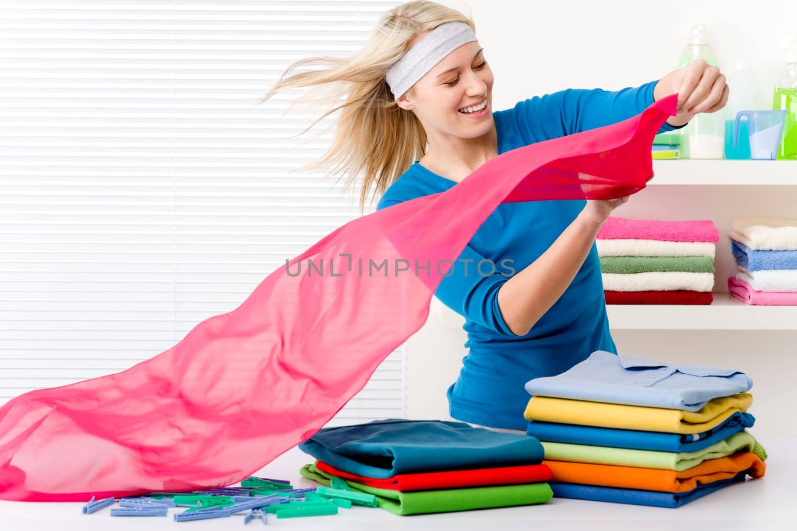 Laundry - woman folding clothes, housework