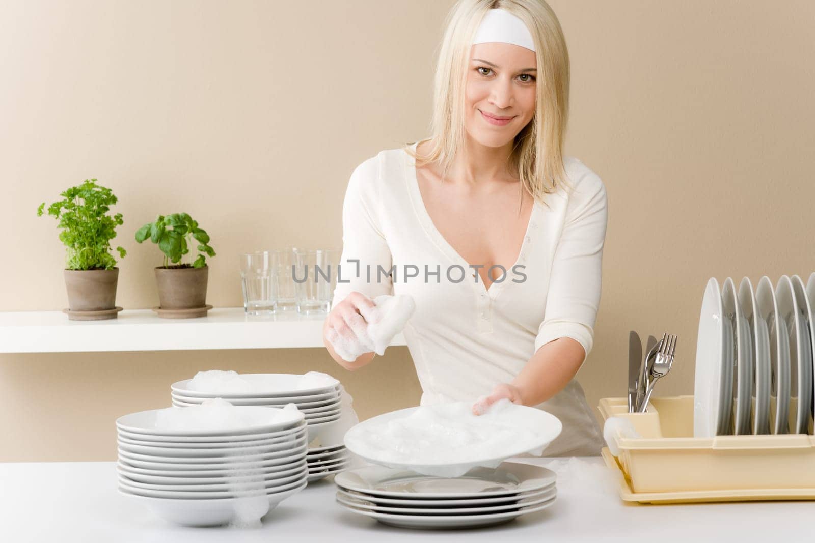 Modern kitchen - happy woman washing dishes, housework