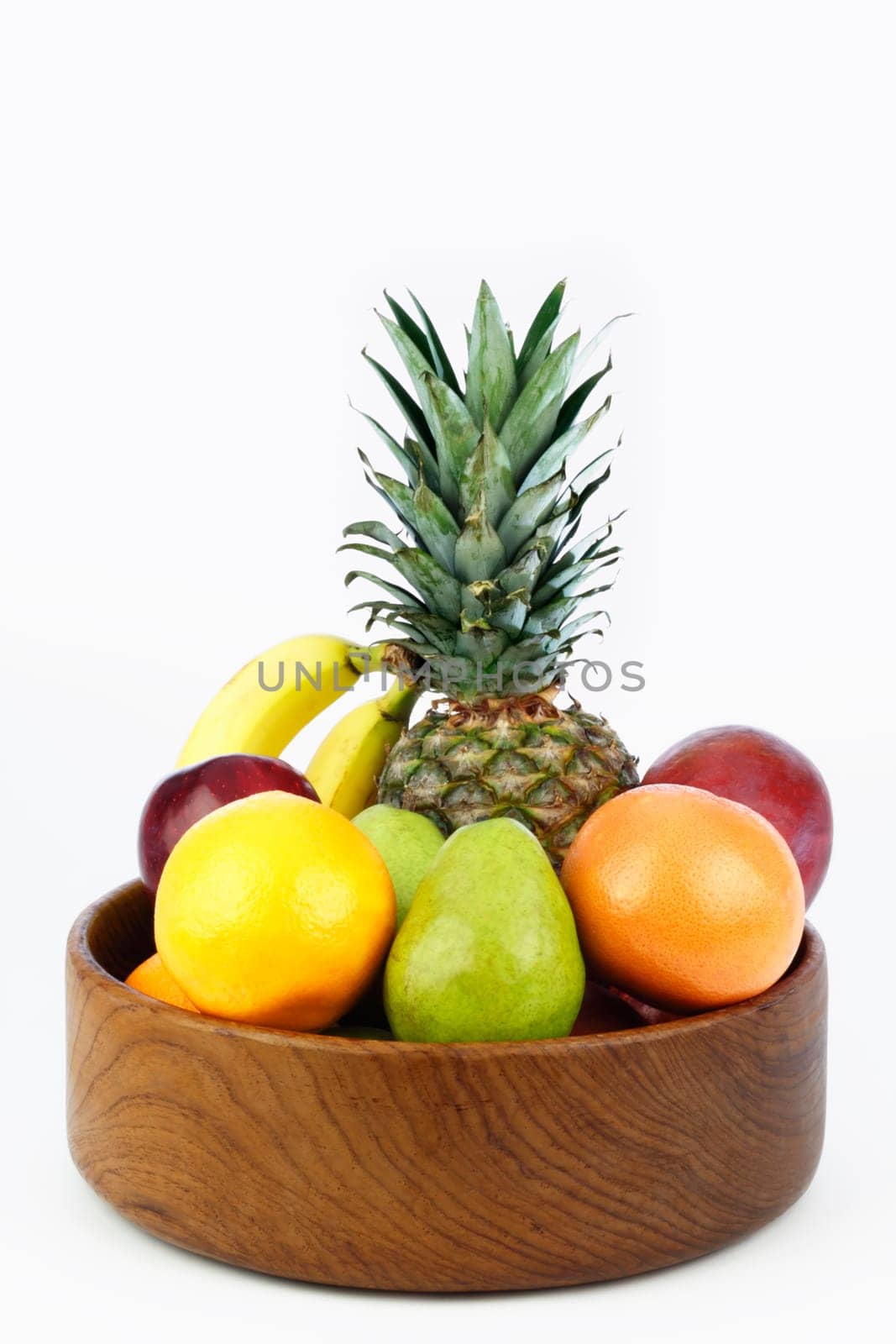 Teak wood bowl holds a mix of tropical and other juicy whole food.
