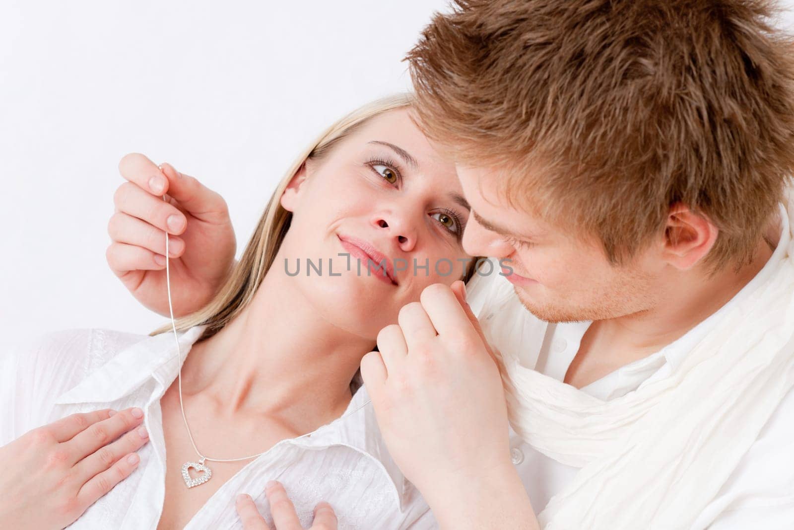 Couple in love - getting present necklace with heart pendant