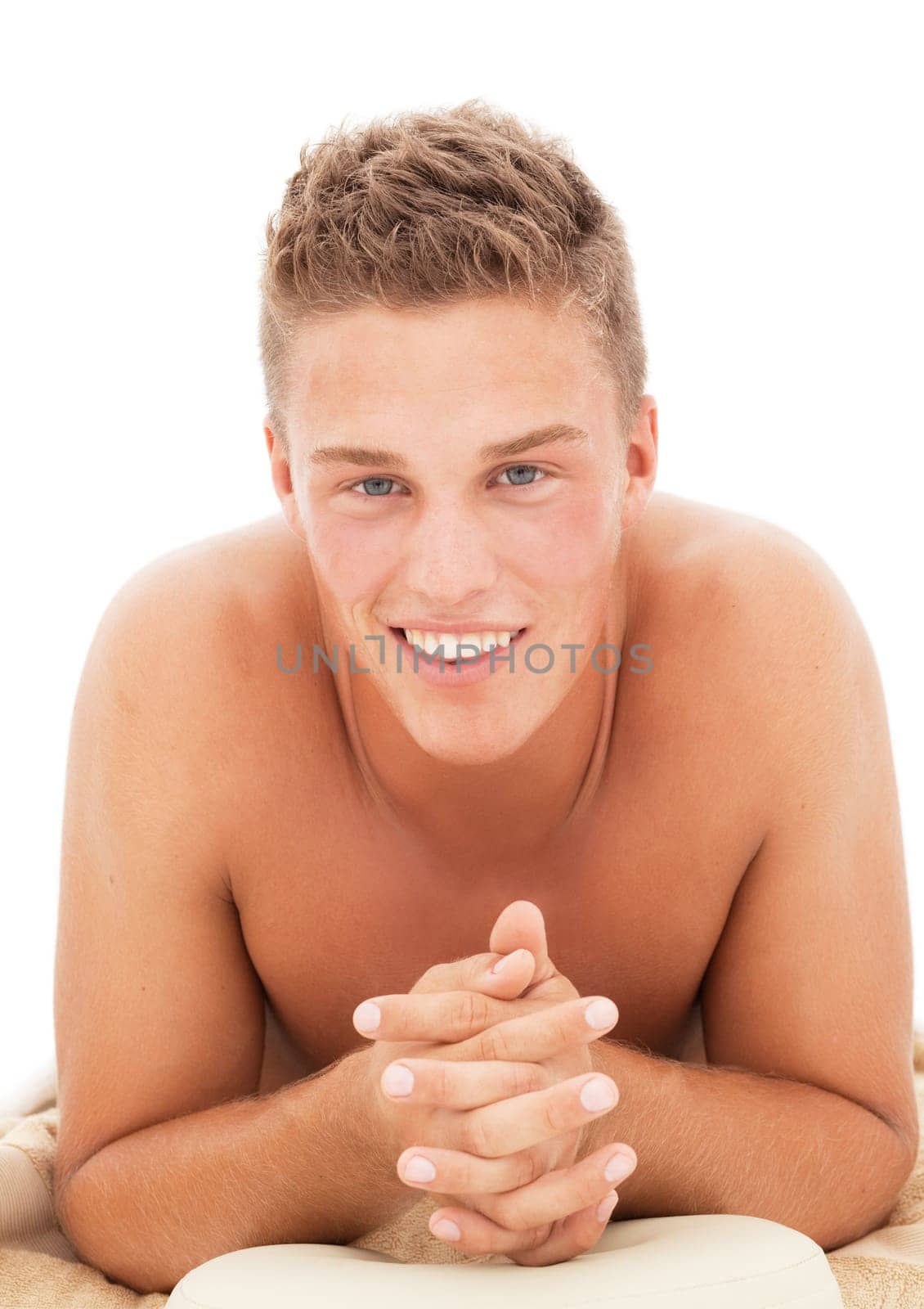Happy young blond man lying undressed in a spa resort
