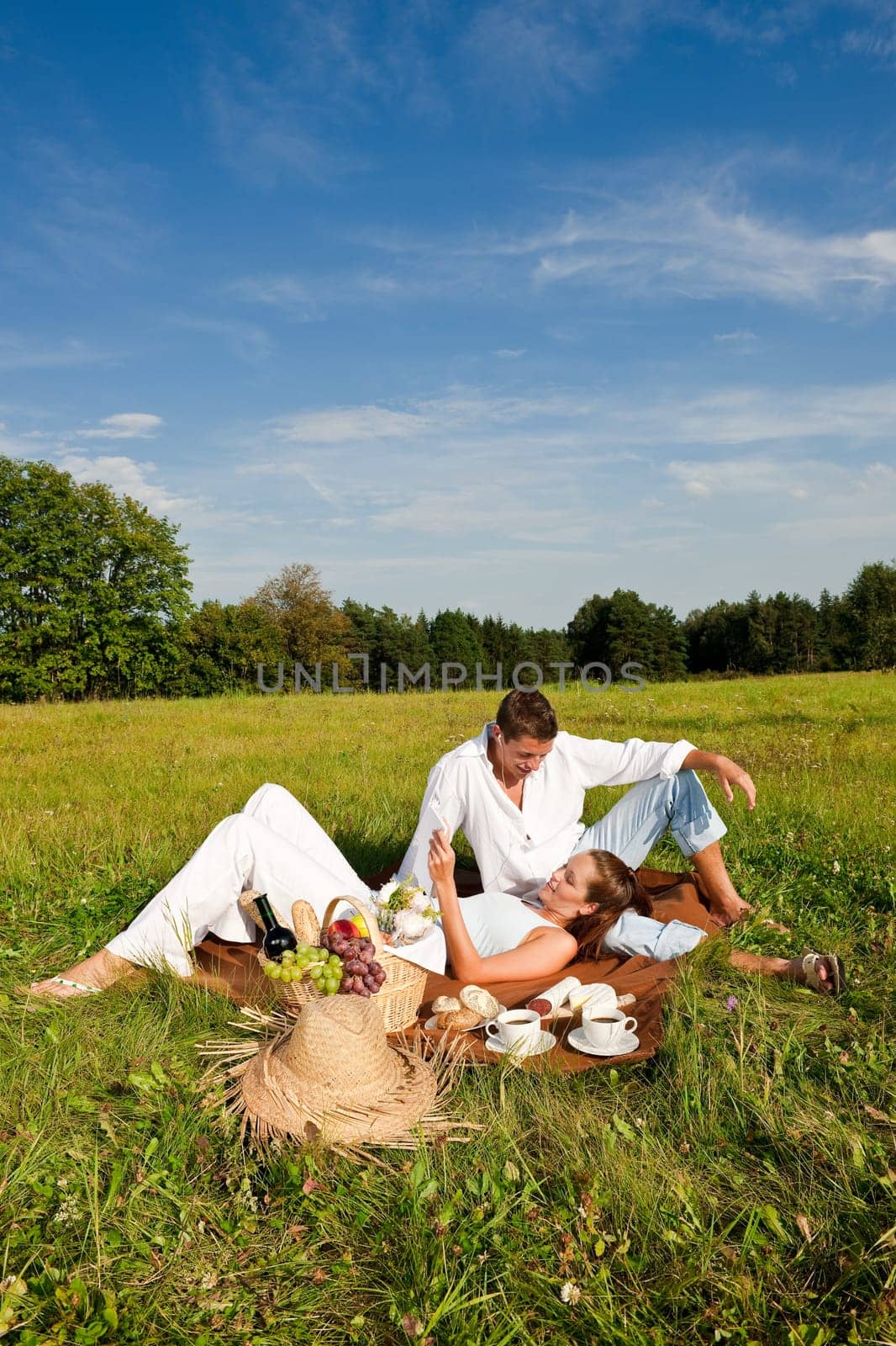 Picnic - Romantic couple in spring nature on sunny day
