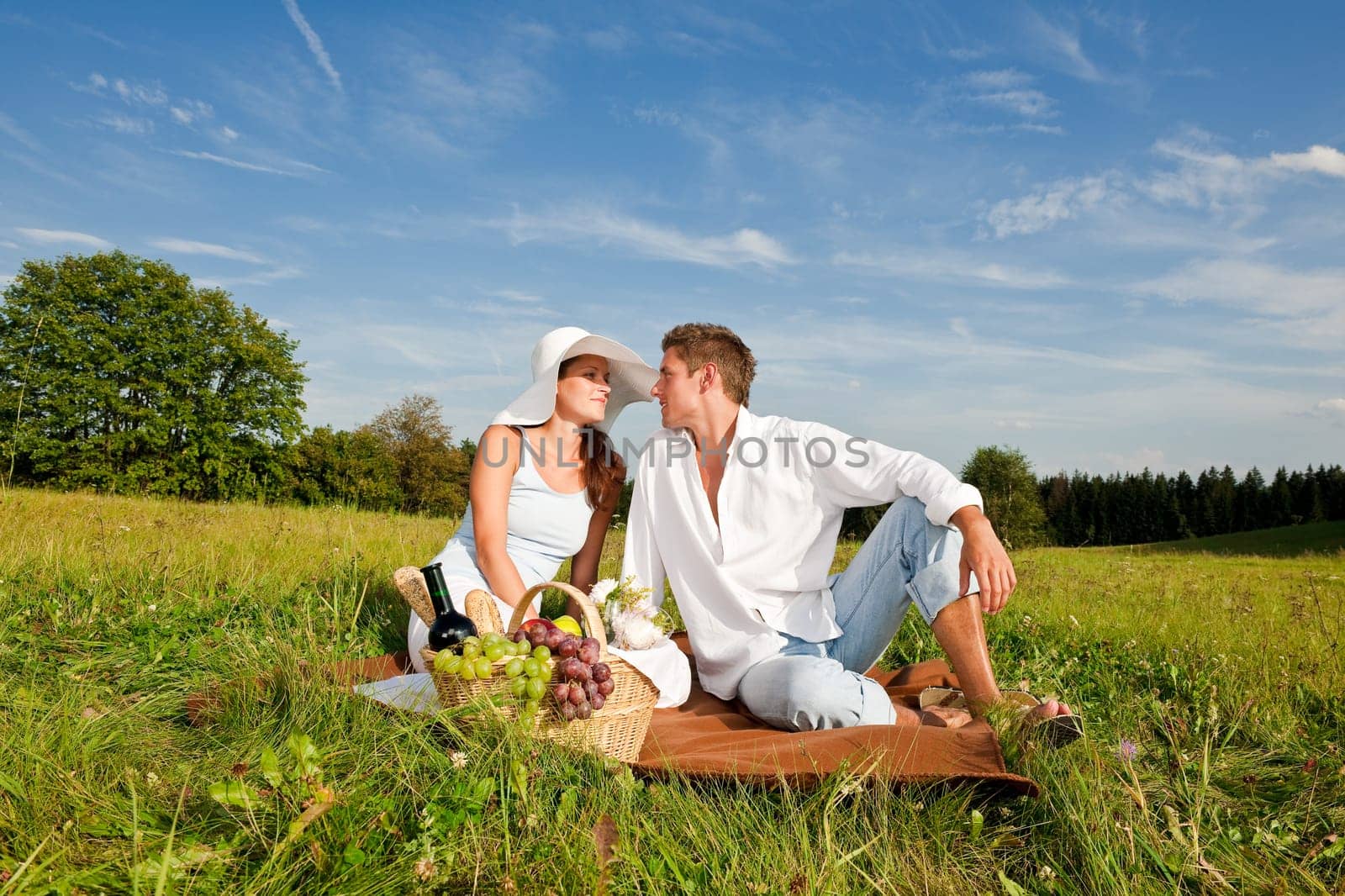 Picnic - Romantic couple in spring nature on sunny day