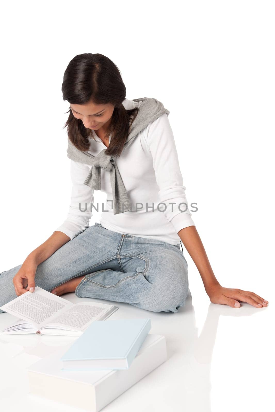 Attractive teenager reading book on white background