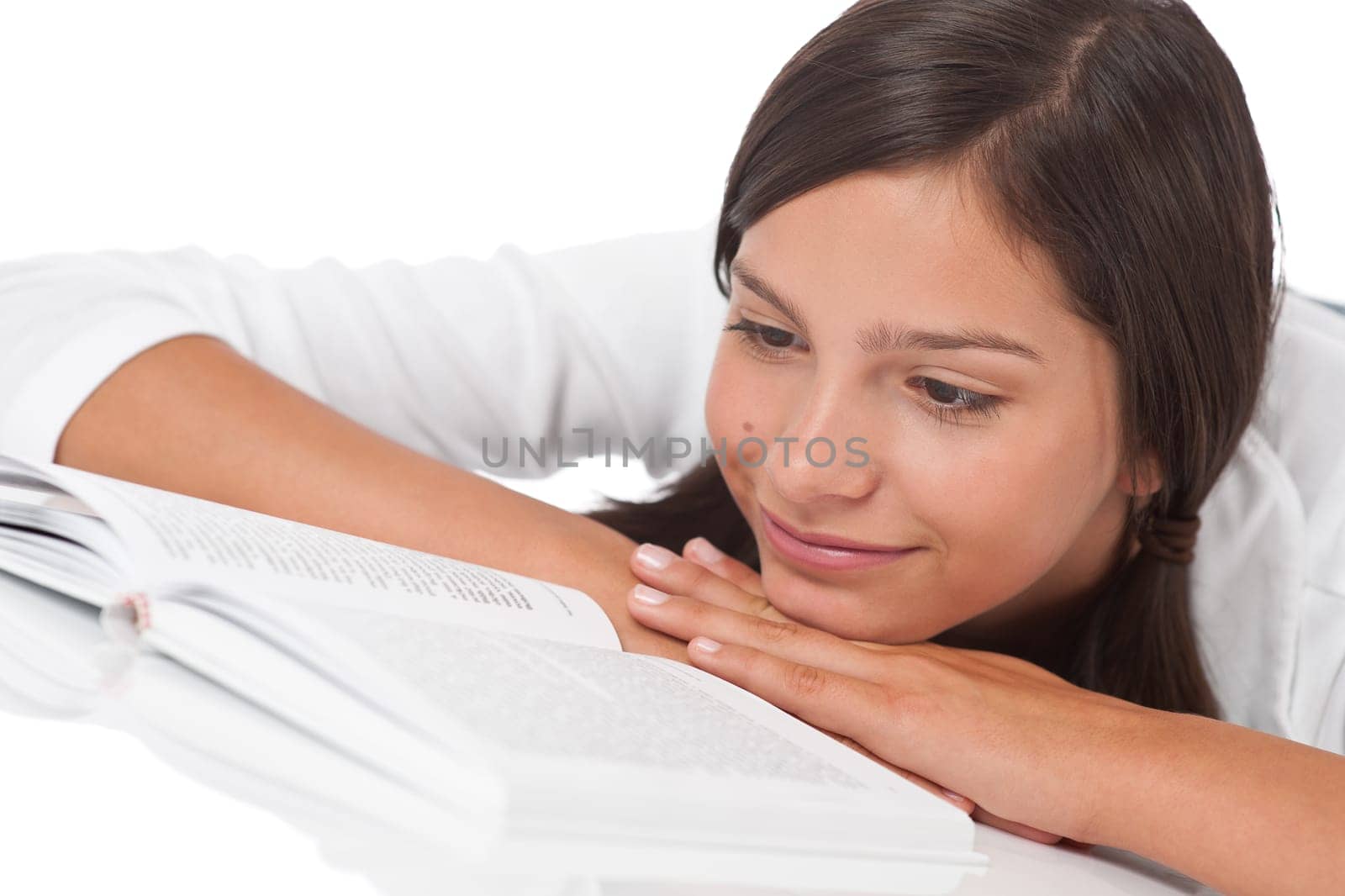 Portrait of teenager reading book on white background
