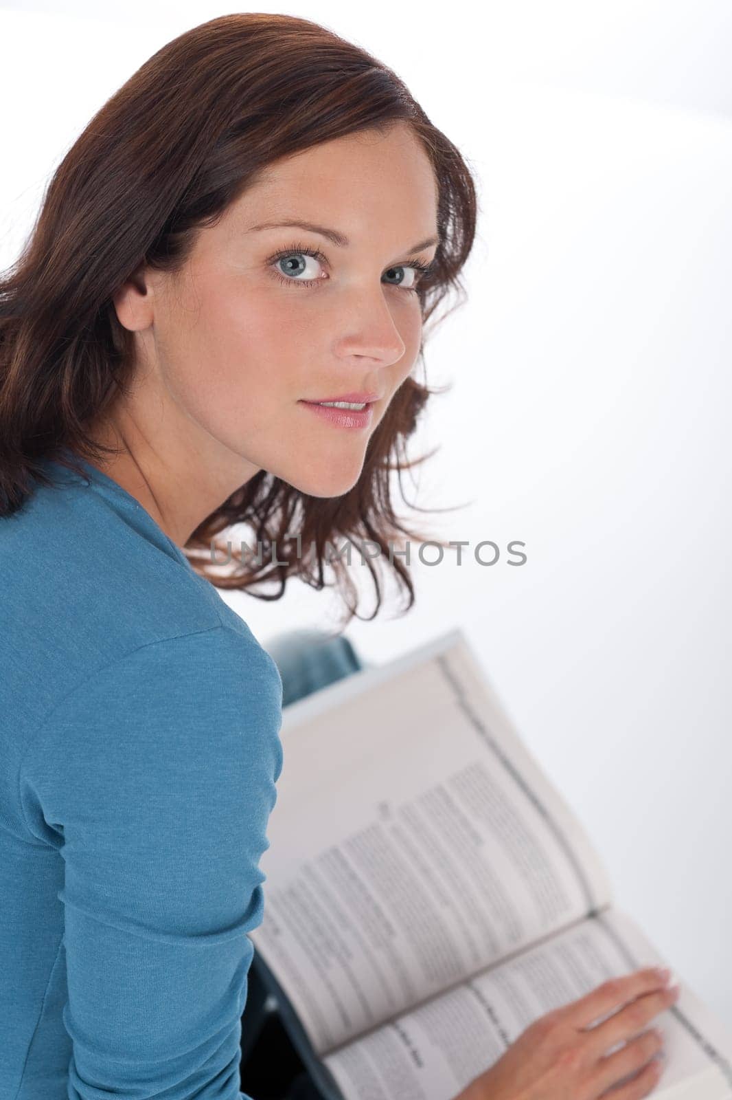 Smiling happy woman with book on white background