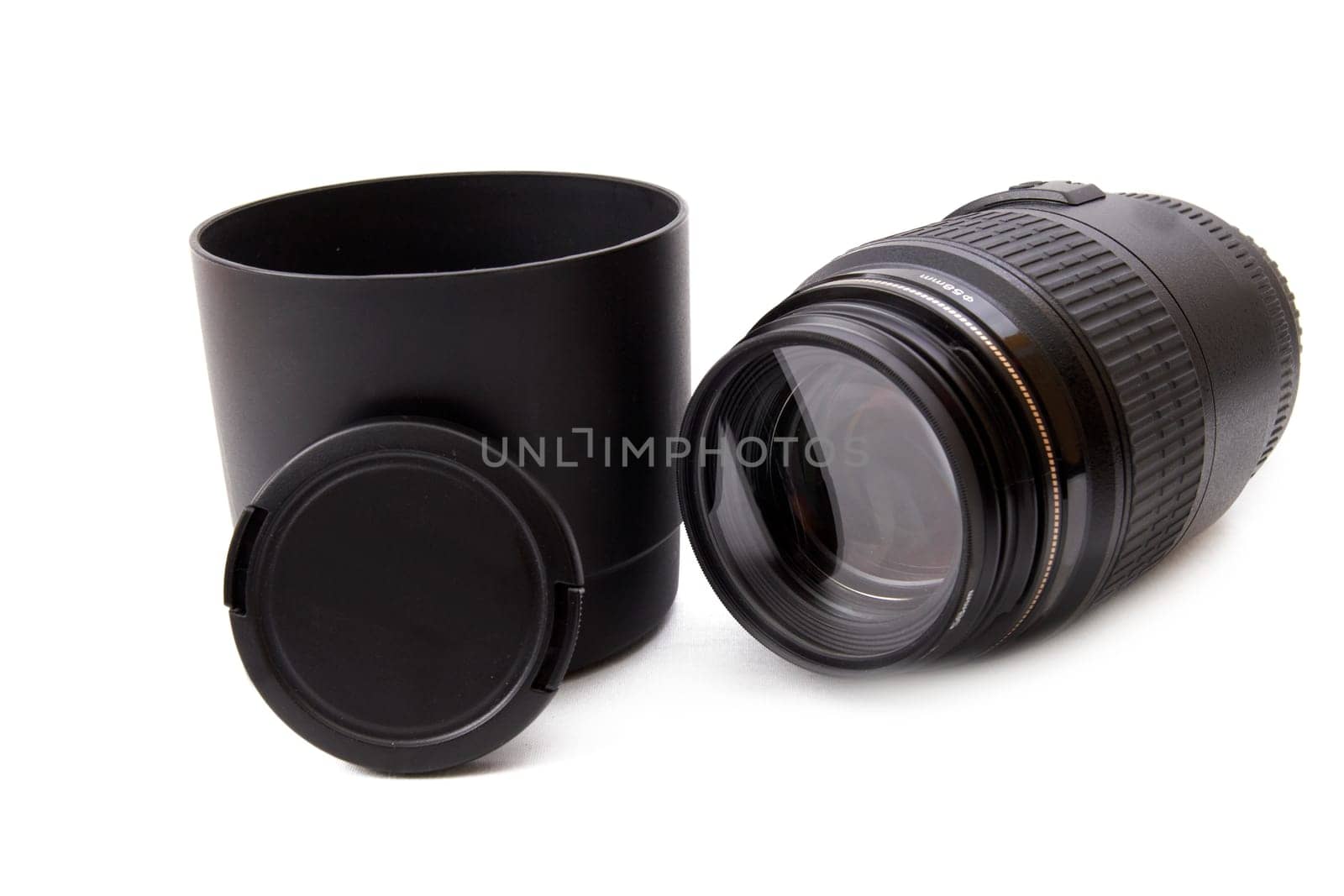 Camera lense, lense hood and lense cap on white background