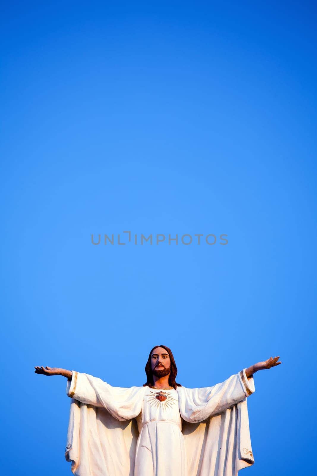 Jesus against clear blue sky, on old church.