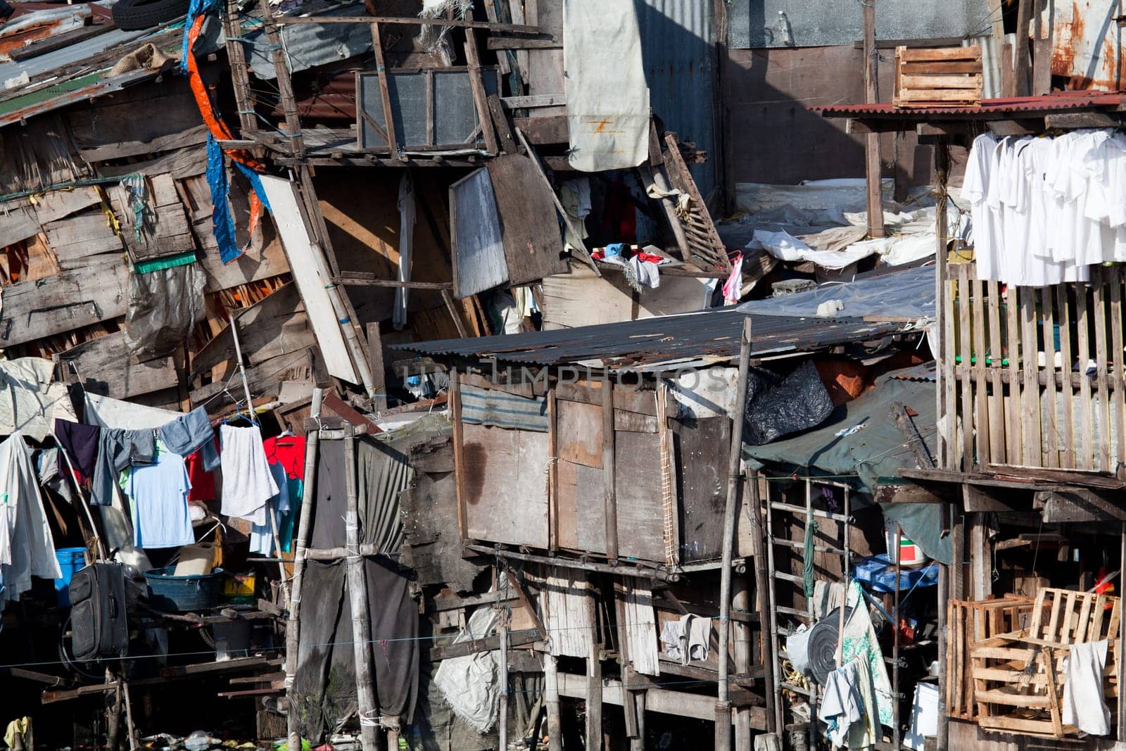 Shanty town - squatter homes. What appears to be a scene of utter disarray and randomness actually portrays several homes. Manila, Philippines. Photo taken using bubble-level.