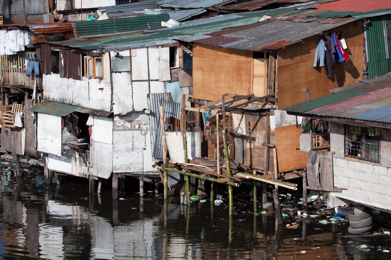 Squatter homes in the Philippines - shacks in shanty town along heavily polluted Paranaque river in Manila.