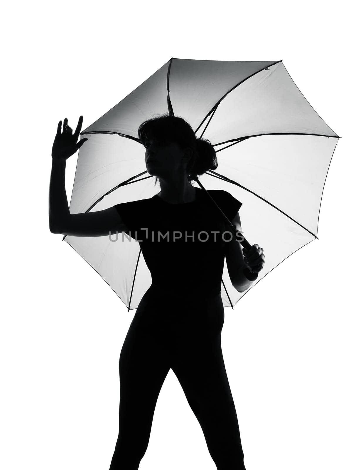 silhouette woman holding open umbrella