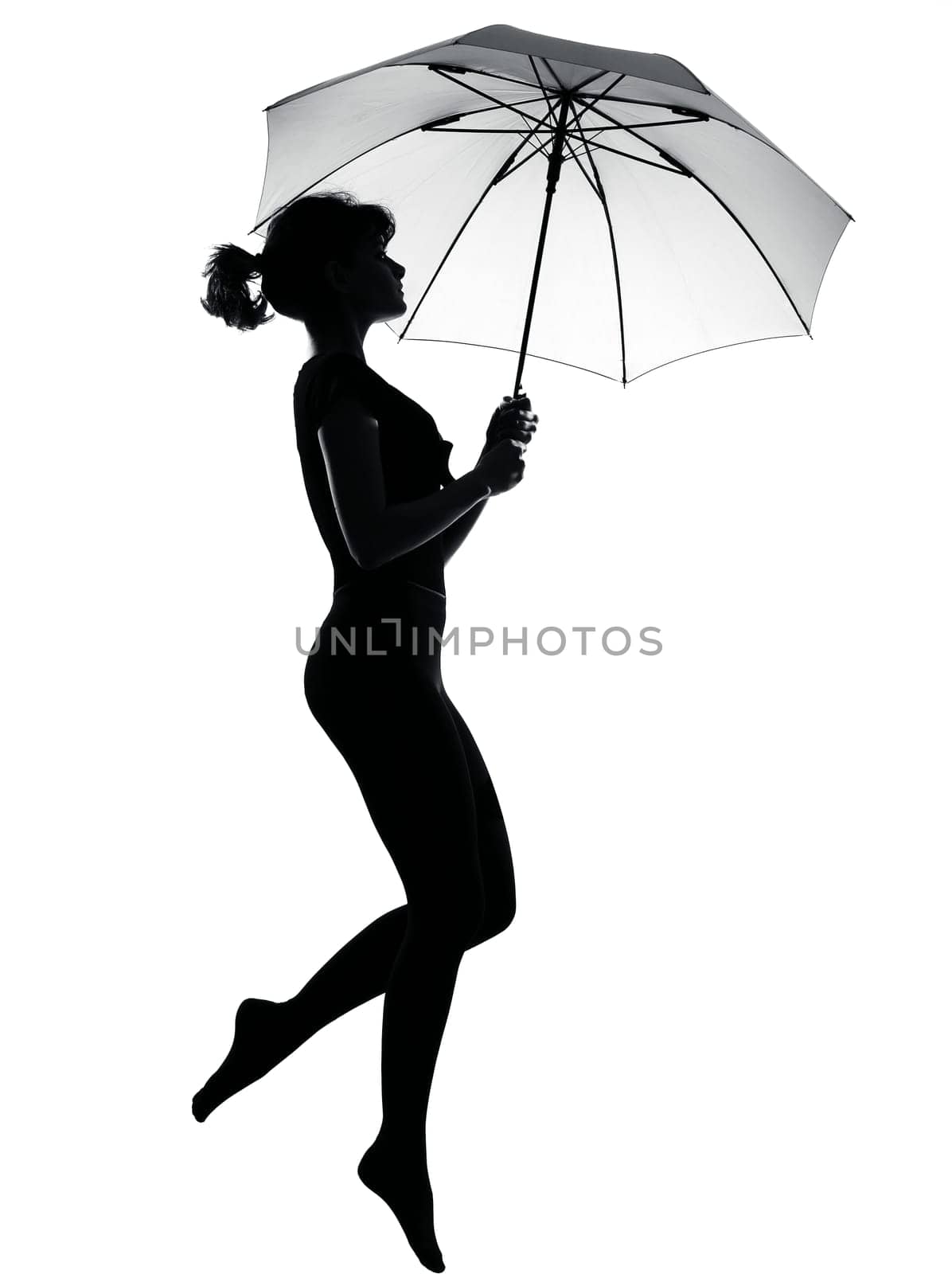 silhouette woman flying  holding open umbrella