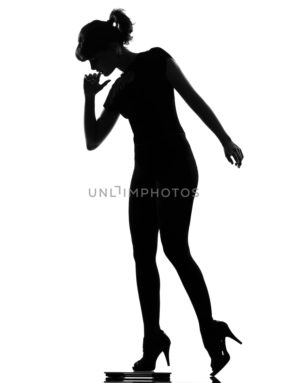 silhouette woman stepping on personal weight scale