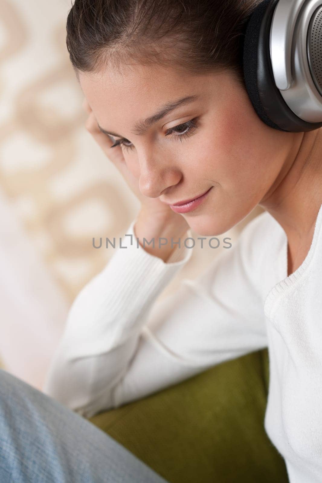Students - Happy female teenager with headphones listening to music in modern lounge