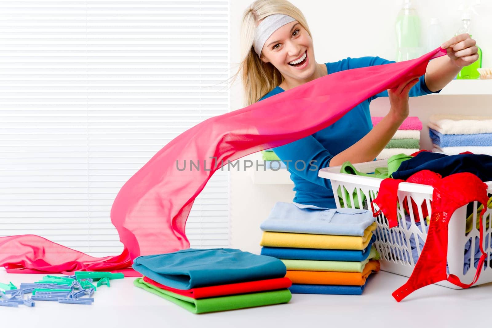 Laundry - woman folding clothes, housework