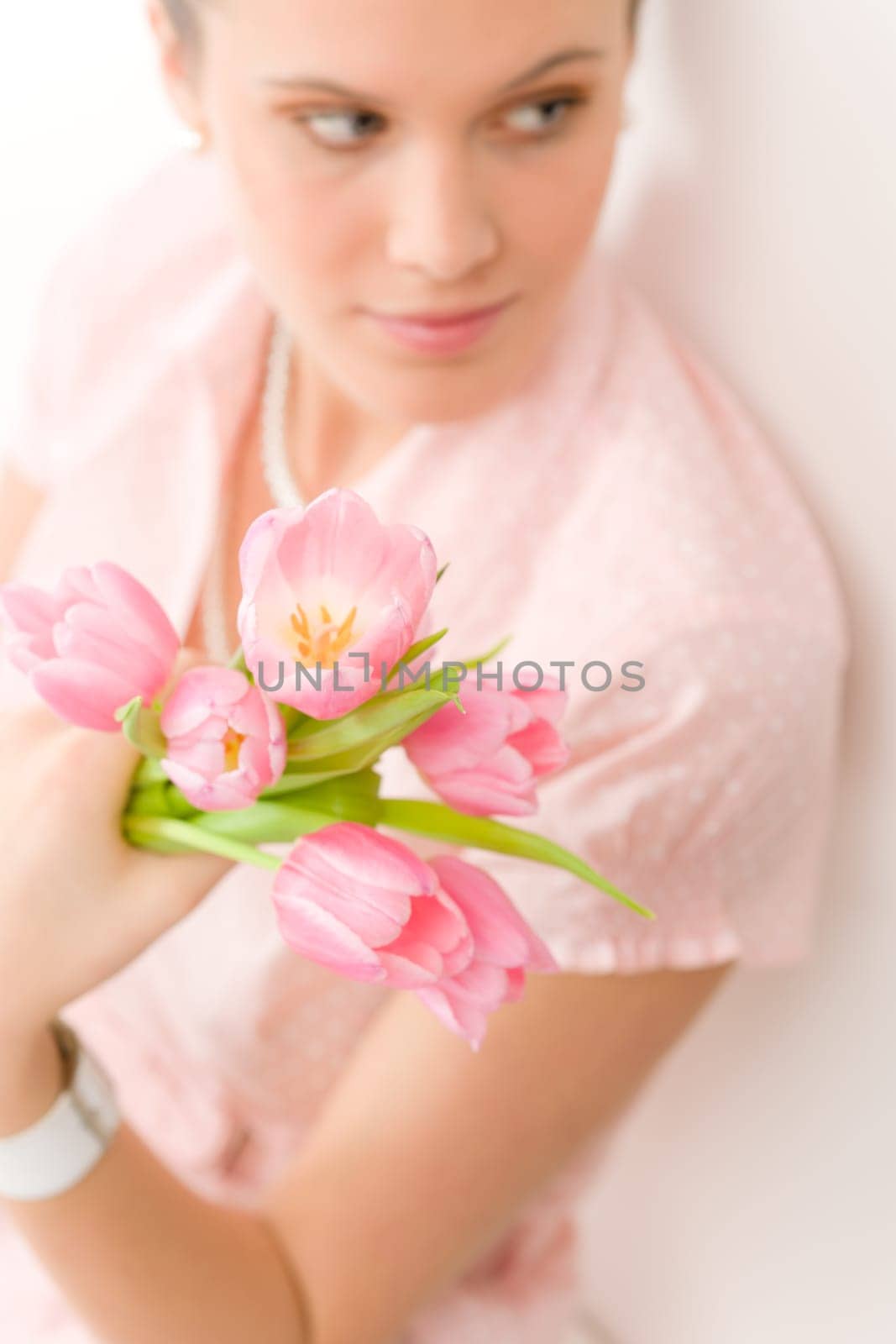 Fashion - young romantic woman in designer clothes with spring tulips