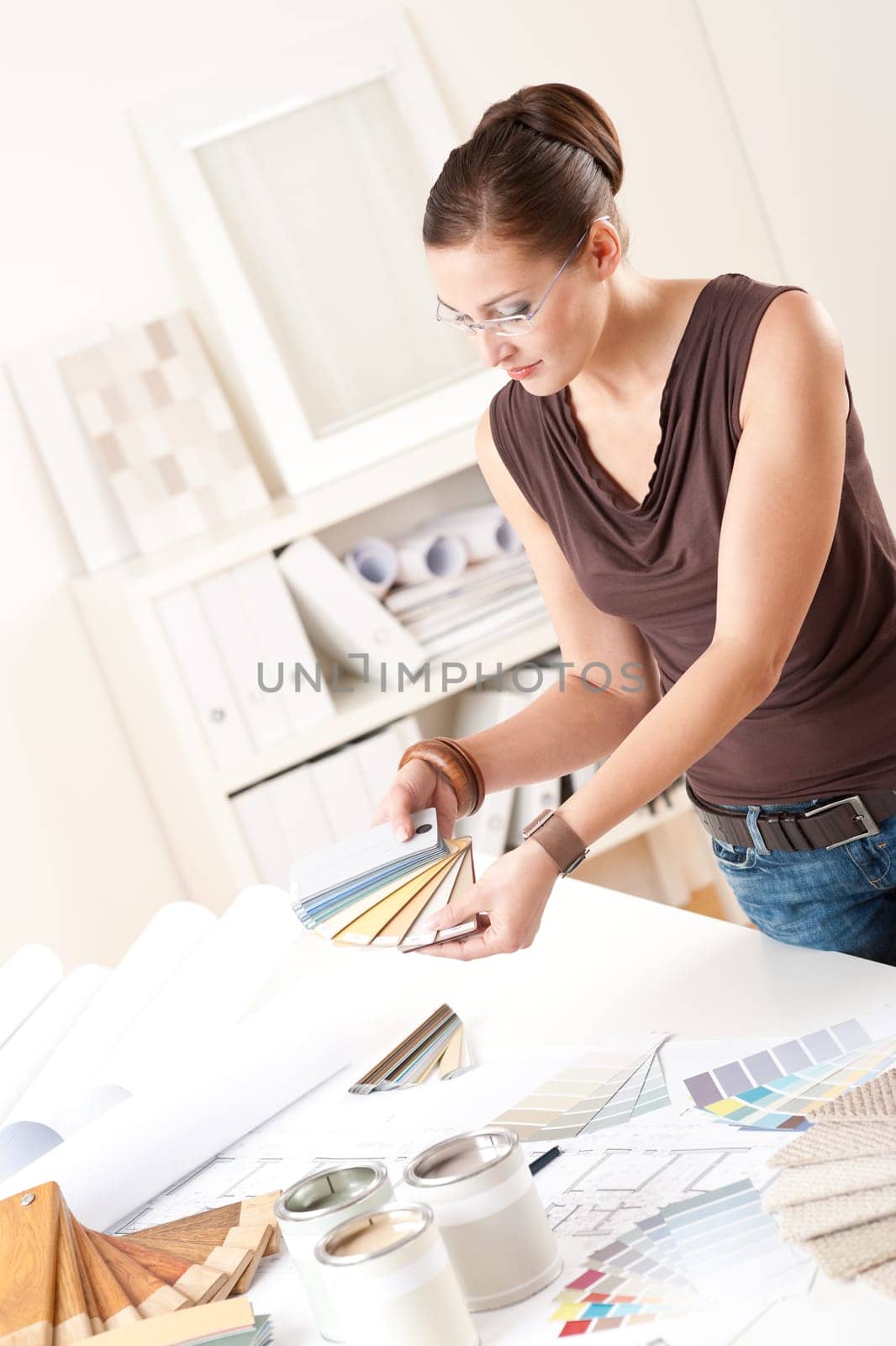 Young female designer at office with color swatches