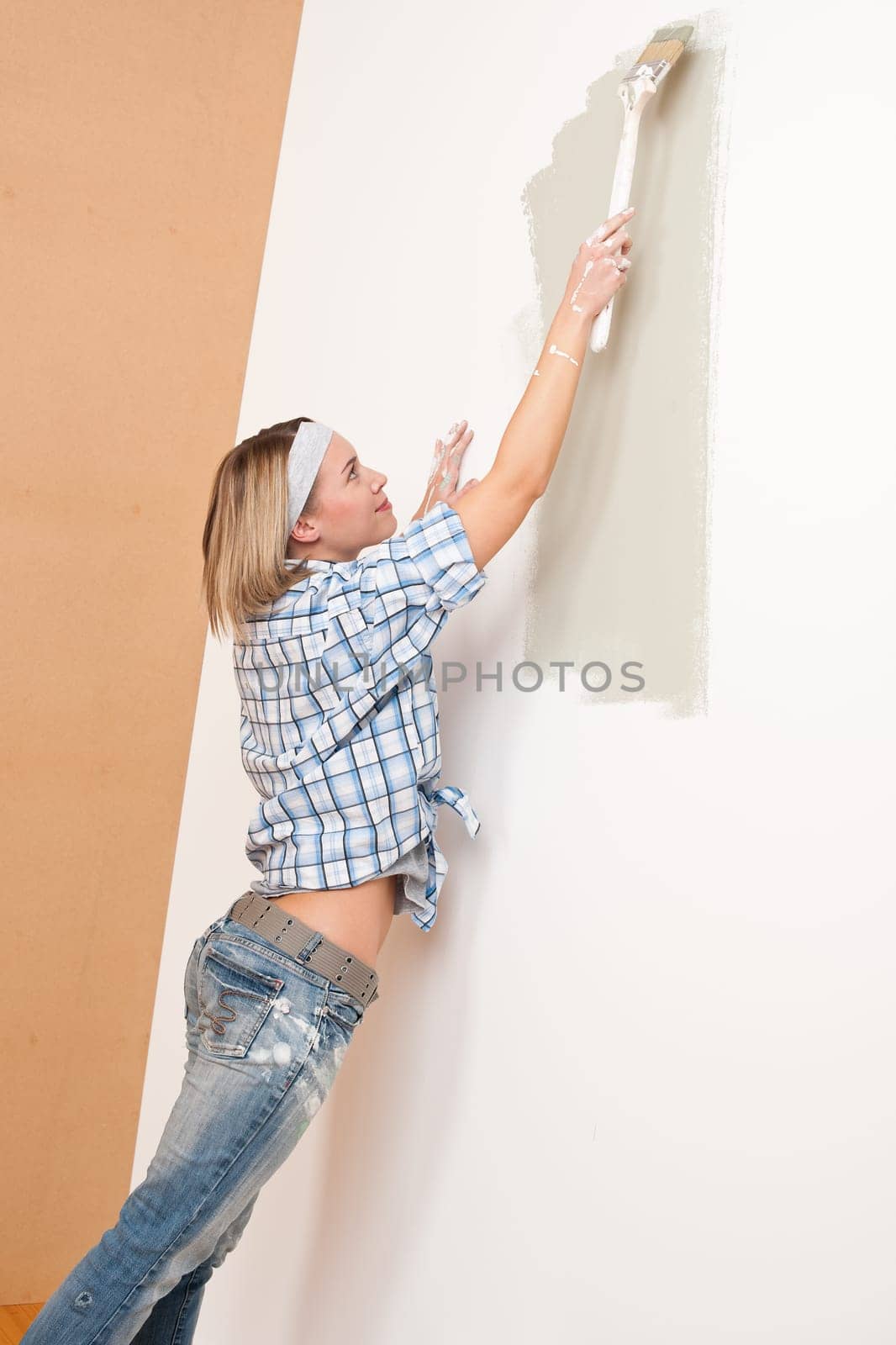 Home improvement: Woman painting wall with paint brush