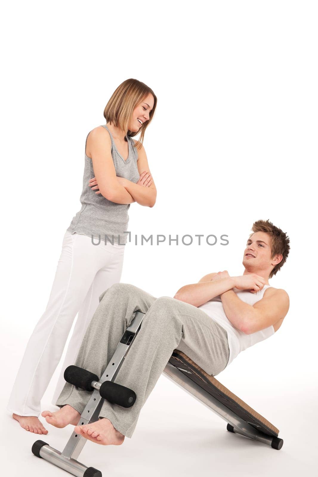Fitness - young man exercising on bench on white background