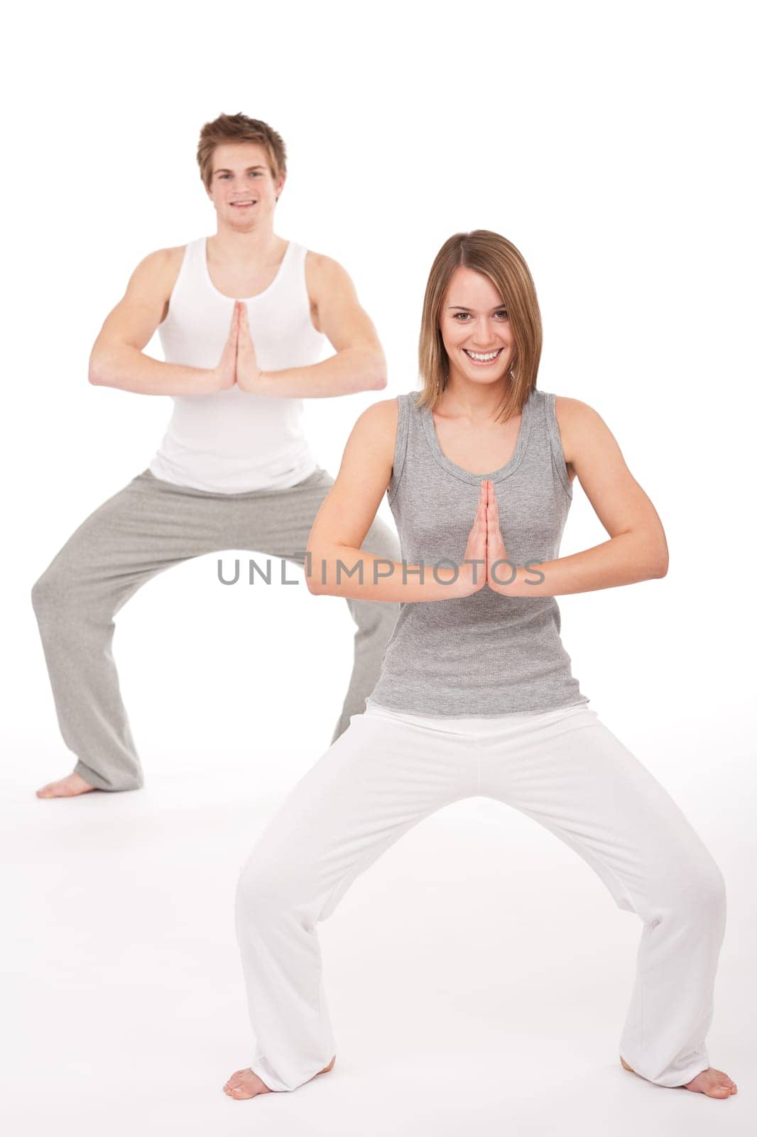 Fitness - Young healthy couple in yoga position on white background