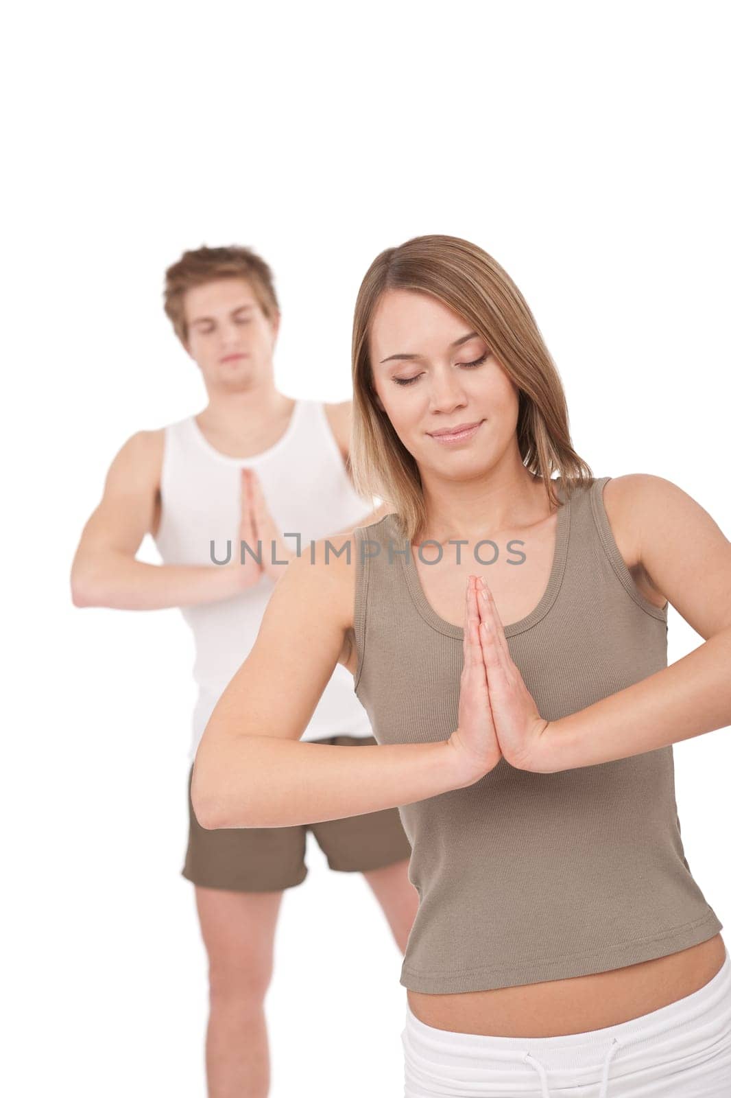Fitness - Young healthy couple in yoga position on white background