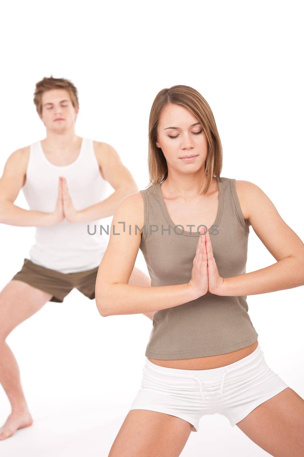 Fitness - Young healthy couple in yoga position on white background