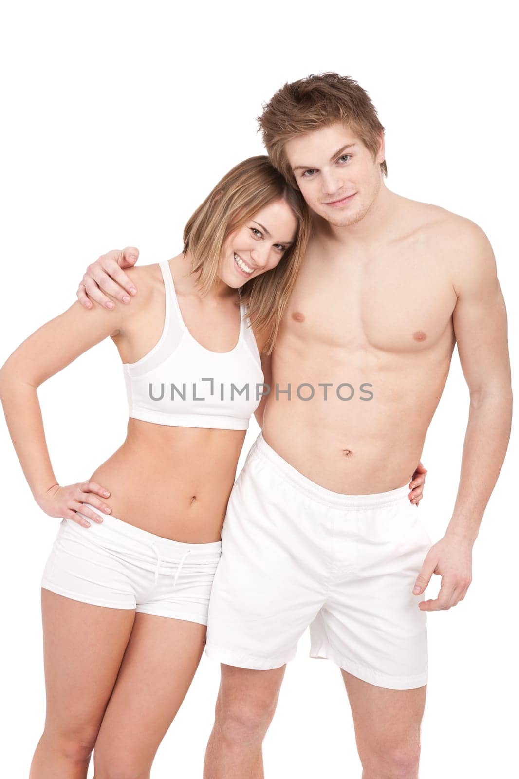 Fitness - Young sportive smiling couple having fun after training on white background