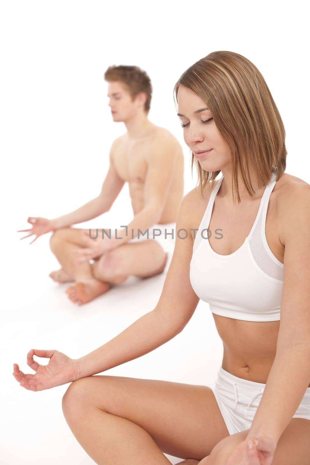 Fitness - Healthy couple stretching in yoga position on white background