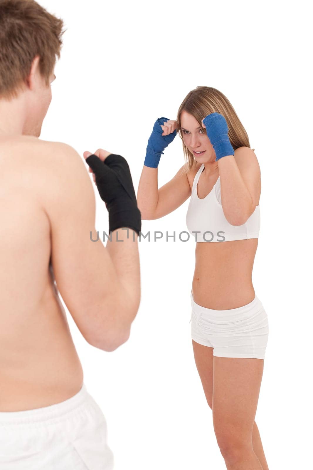 Boxing - Young woman in class training with instructor on white, hands with handwraps