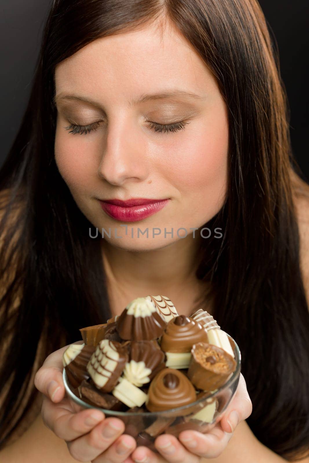 Chocolate - portrait young healthy woman enjoy smell candy