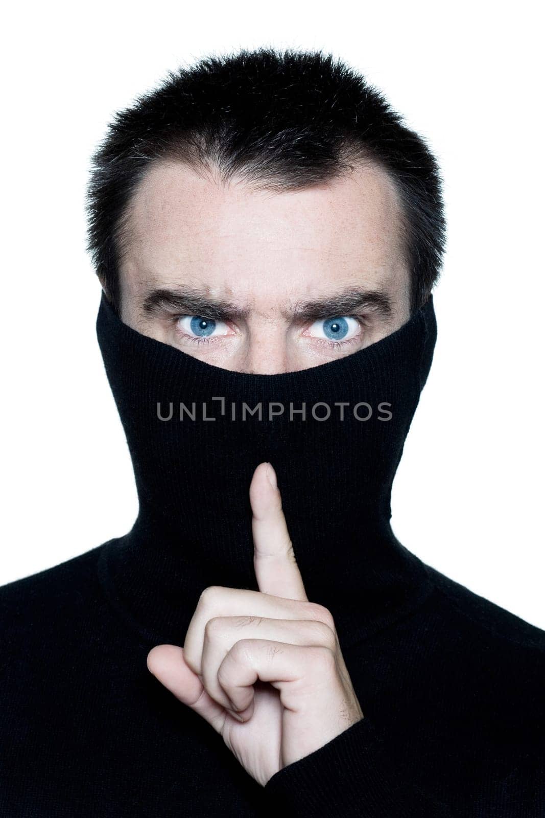 caucasian man portrait behind his turtle polo neck gesturing silence portrait on studio isolated white background