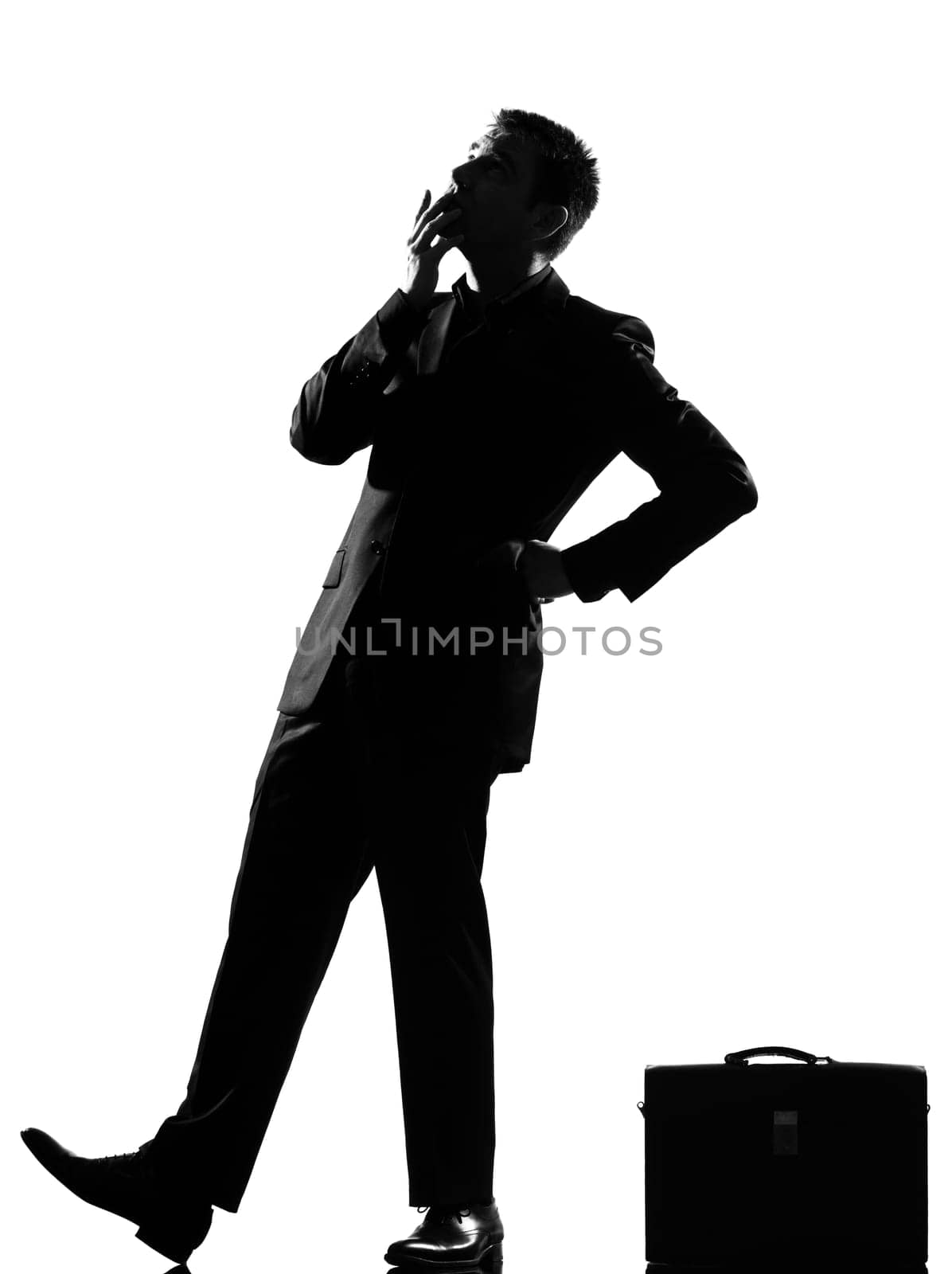 silhouette caucasian business man thinking pensive behavior  looiking up full length on studio isolated white background