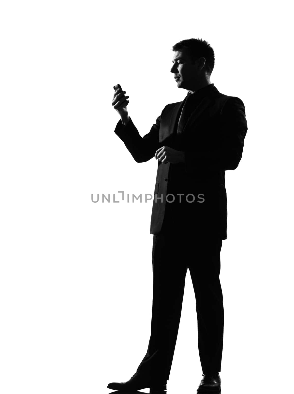 silhouette caucasian business man on the phone  sms text messaging full length on studio isolated white background