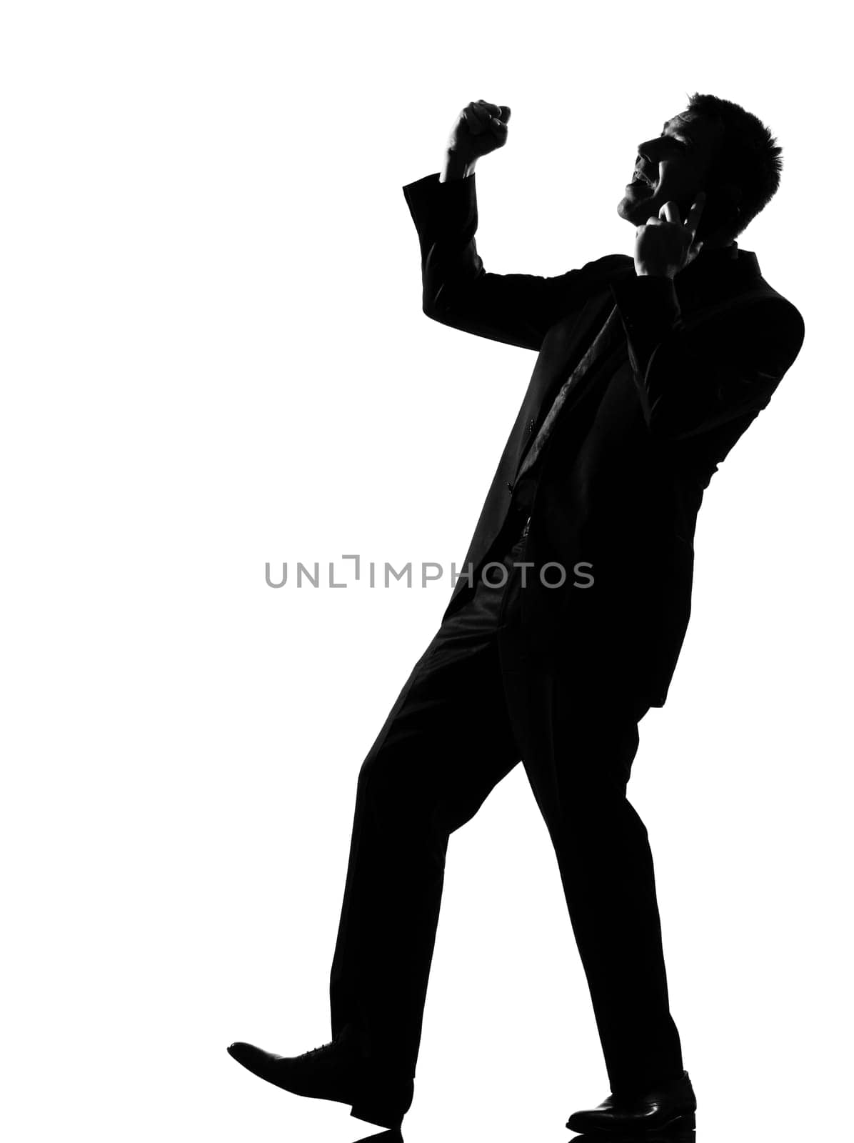 silhouette caucasian business man  expressing winning on the phone behavior full length on studio isolated white background