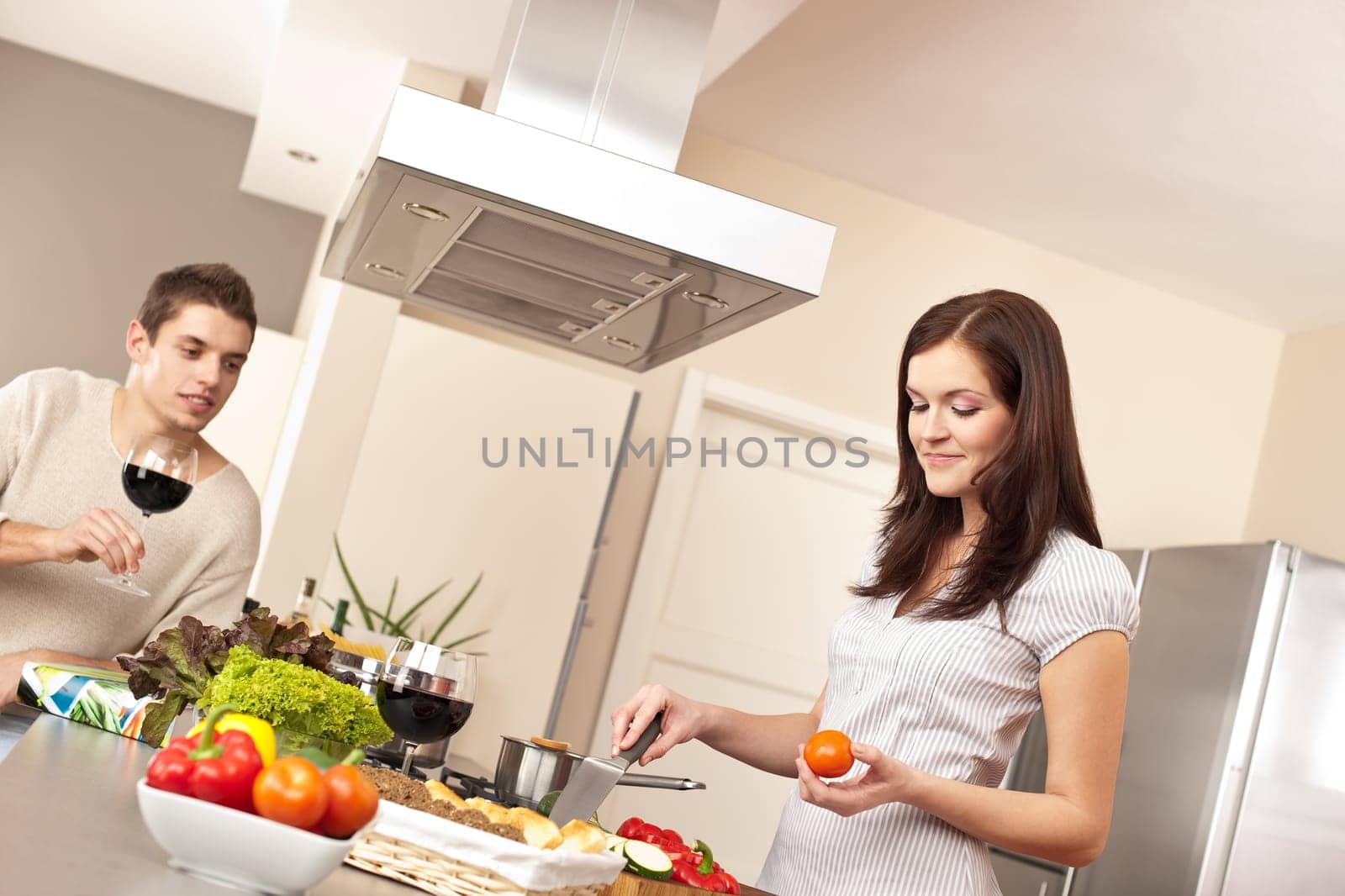 Young couple cooking in modern kitchen together