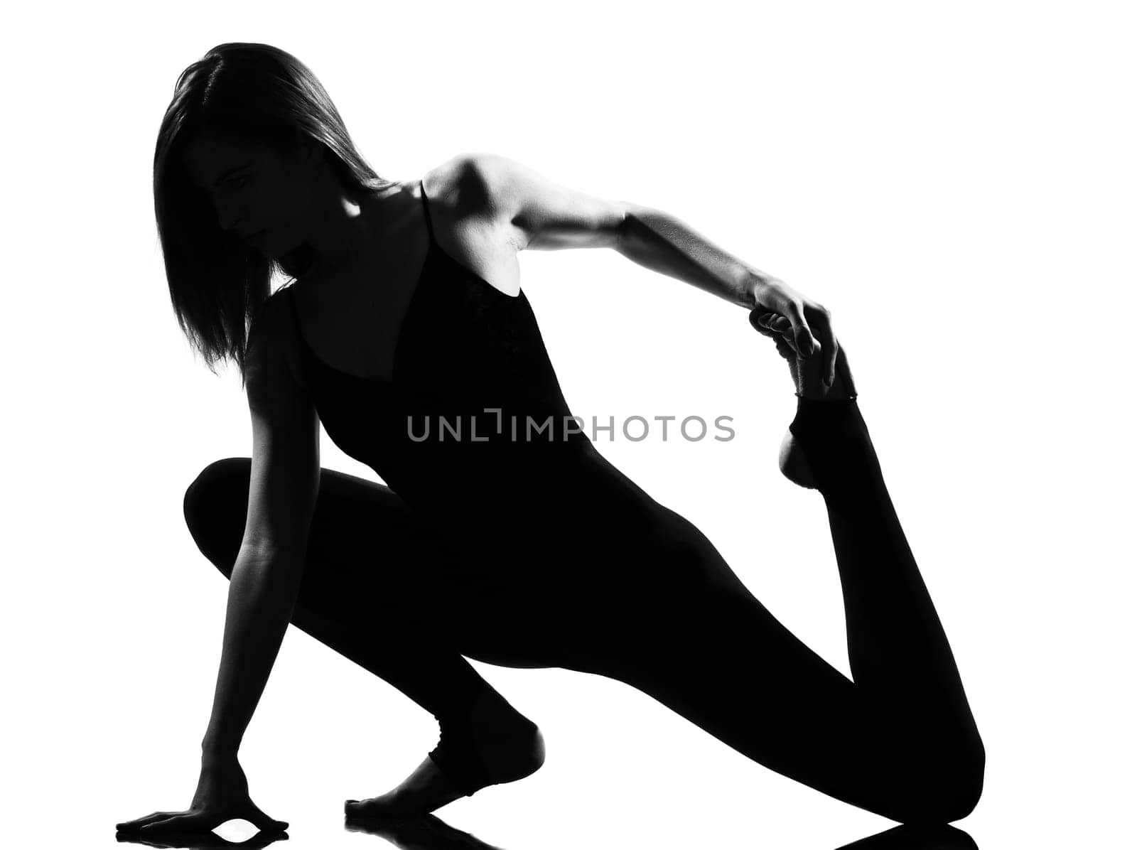 beautiful caucasian tall woman ballet dancer stretching warming up full length on studio isolated white background