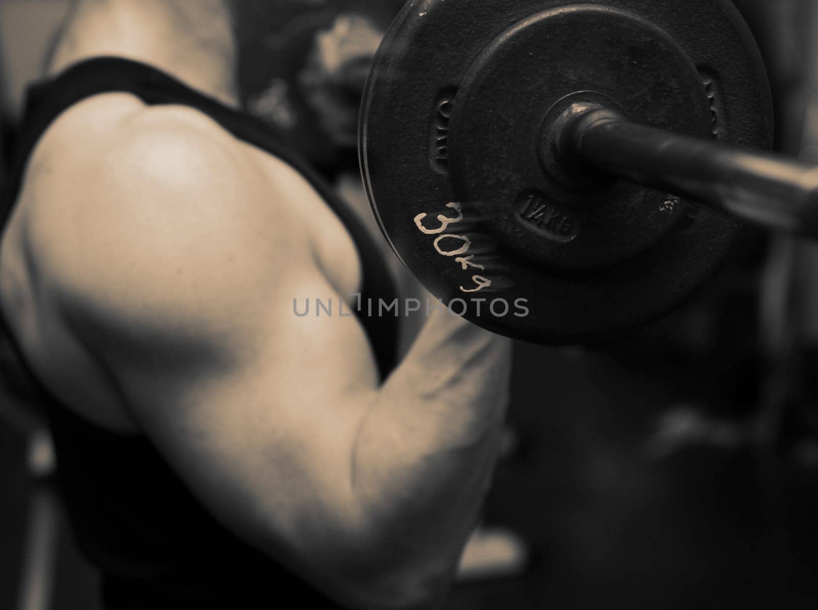 bodybuilding workout in gym. Male lifting free weights. training with barbell to build muscle and biceps