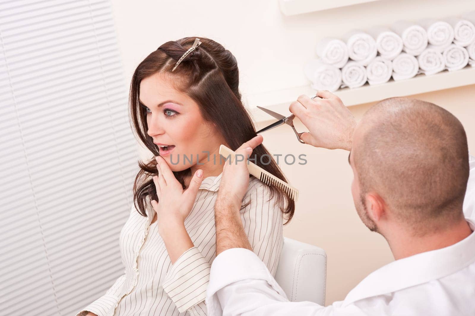 Professional male hairdresser cut with scissors at salon, customer getting new haircut