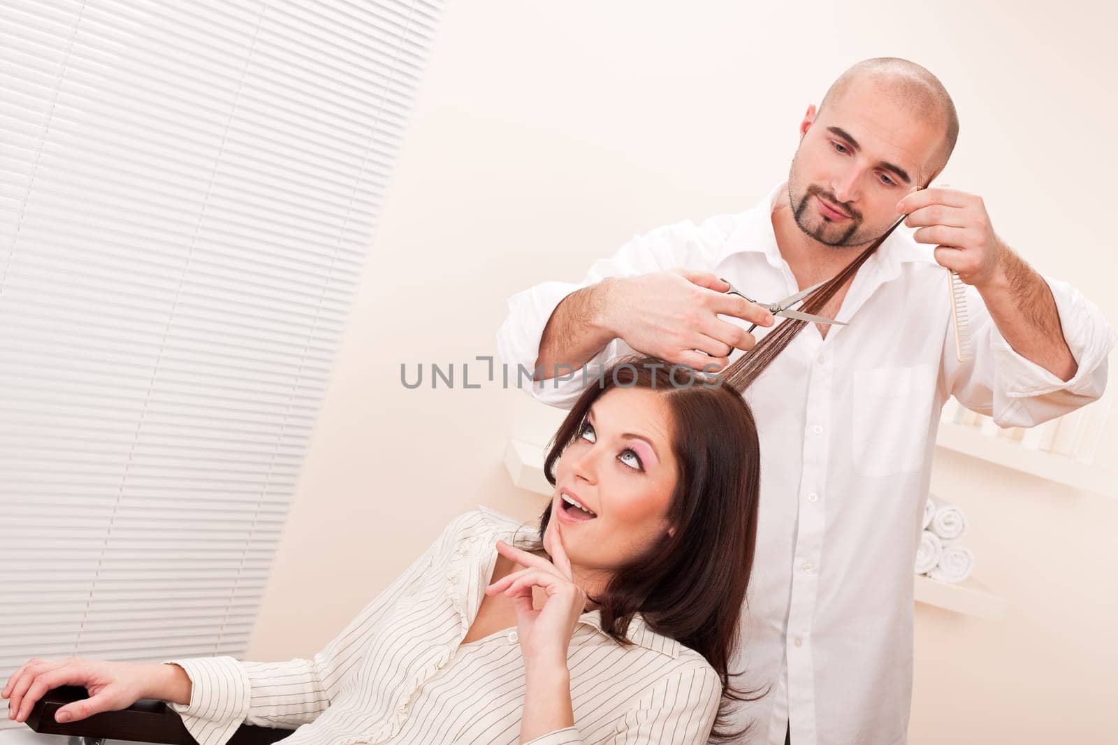 Professional male hairdresser cut with scissors at salon, customer getting new haircut