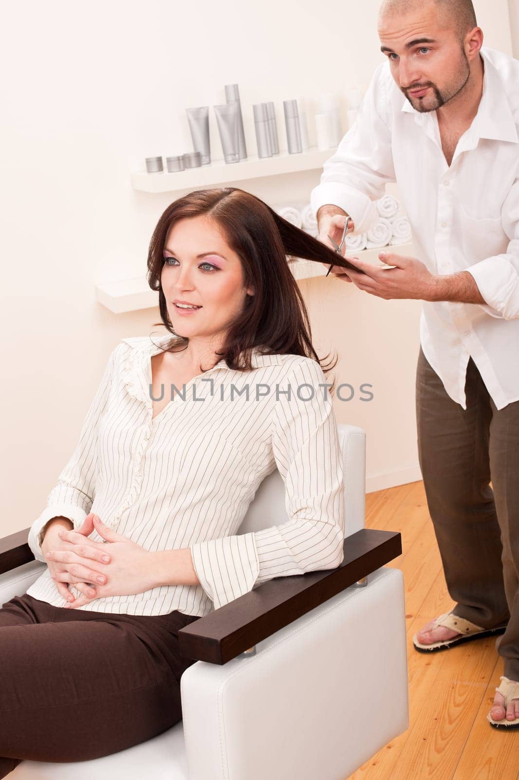 Professional male hairdresser cut with scissors at salon, customer getting new haircut