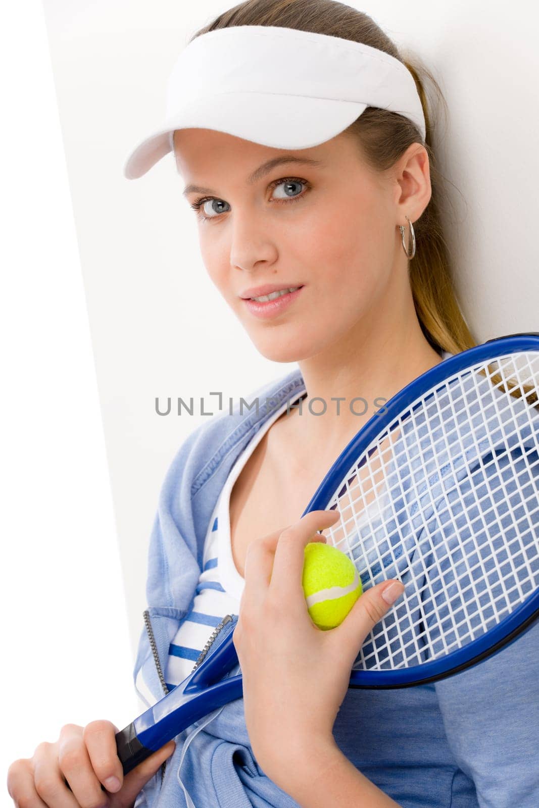 Tennis player - young woman holding racket in fitness outfit