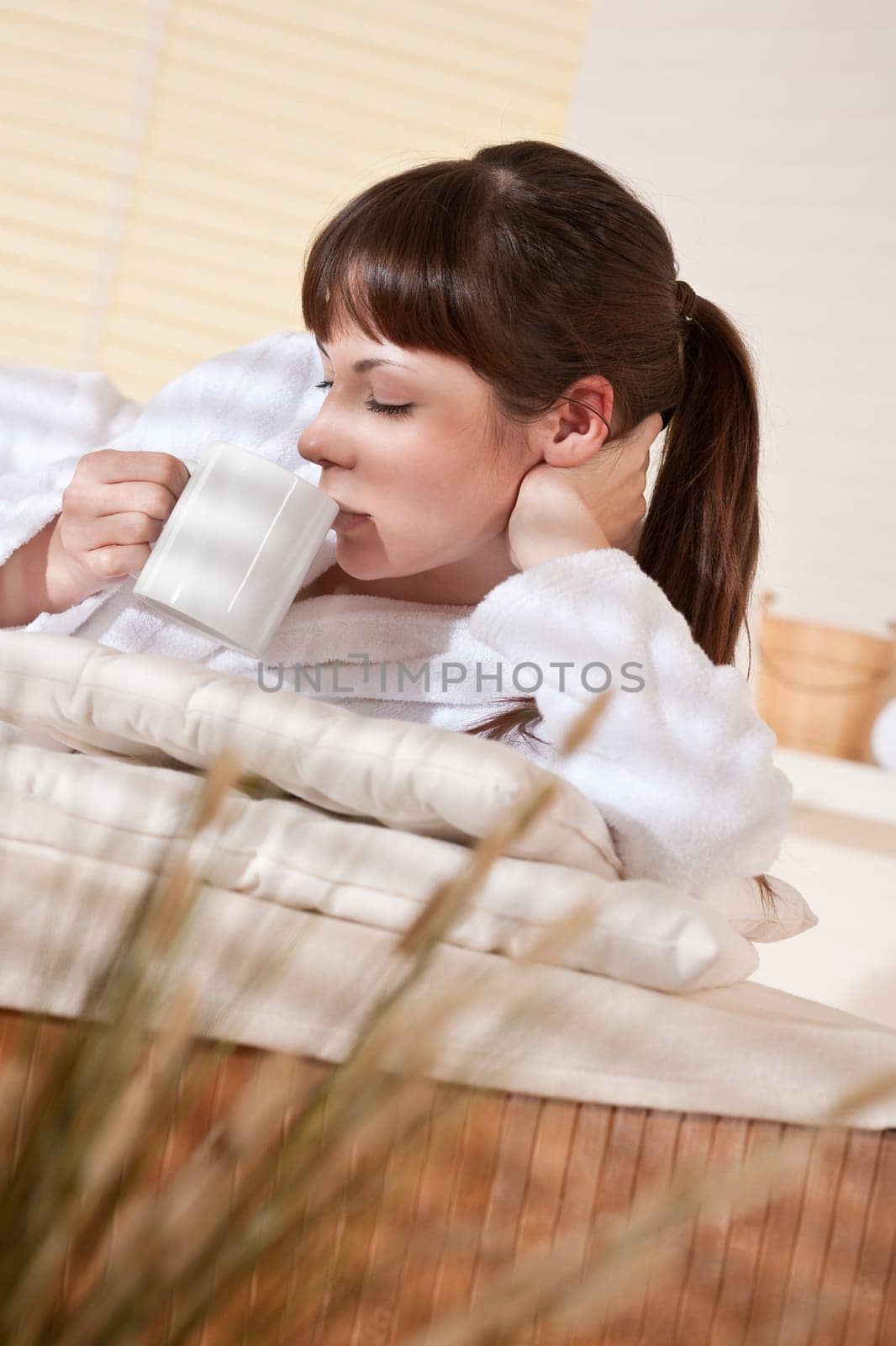 Spa - Young woman at wellness therapy relaxing after massage