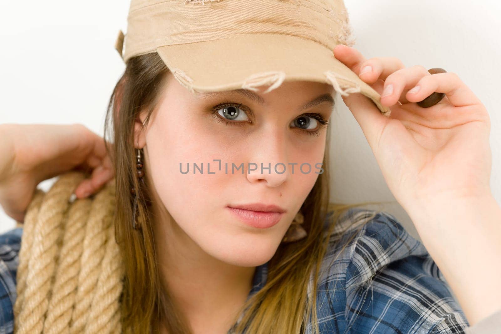 Fashion model - young woman country style posing with rope