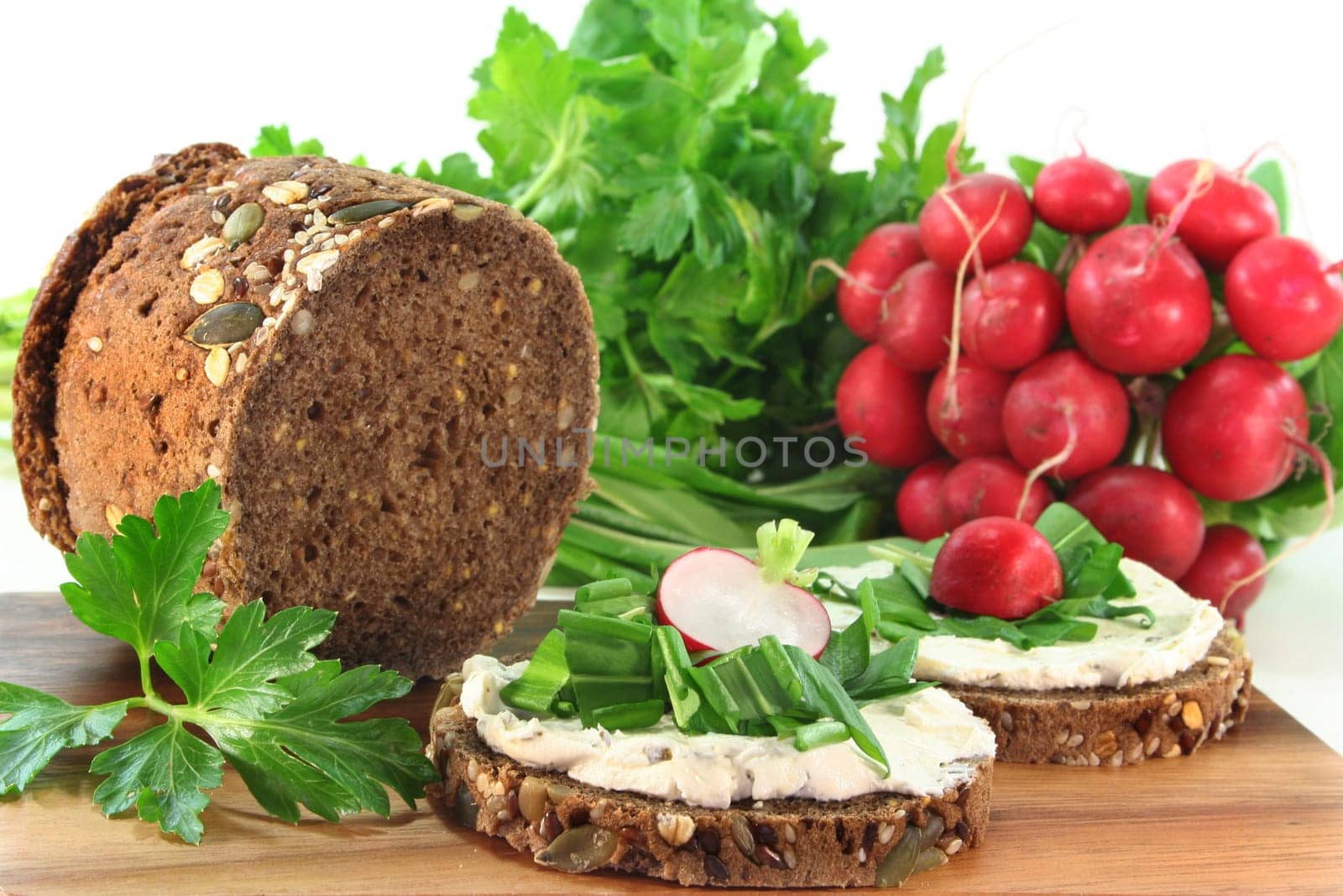 a slice of bread topped with cream cheese and fresh wild garlic